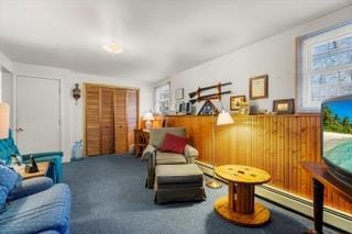 living area with baseboard heating and carpet floors