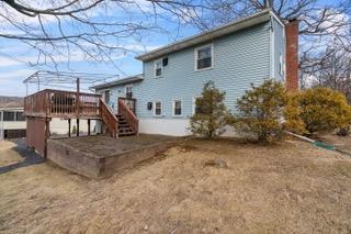 back of house featuring a wooden deck