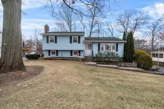 split level home featuring a front lawn