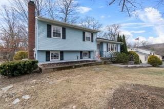 tri-level home with a front yard