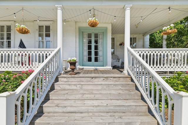 45 Shore Rd, East Setauket, NY 11733 - view of exterior entry featuring covered porch and concrete block siding