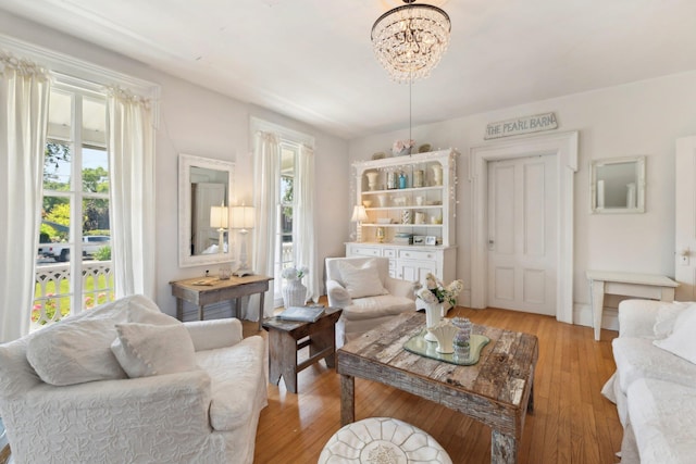 sitting room featuring light hardwood / wood-style floors, an inviting chandelier, and a healthy amount of sunlight