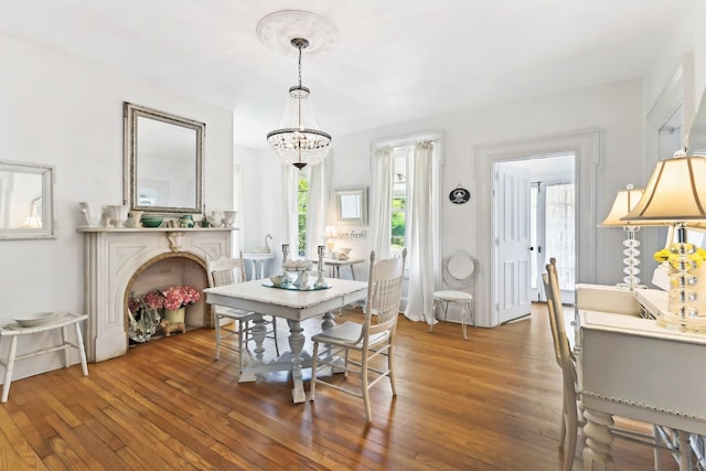 dining room with a notable chandelier and dark hardwood / wood-style floors