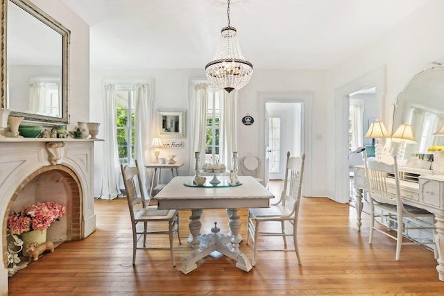 dining area featuring light hardwood / wood-style floors and a chandelier