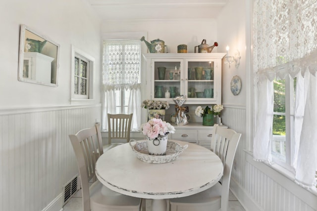 45 Shore Rd, East Setauket, NY 11733 - dining space featuring wainscoting and a decorative wall