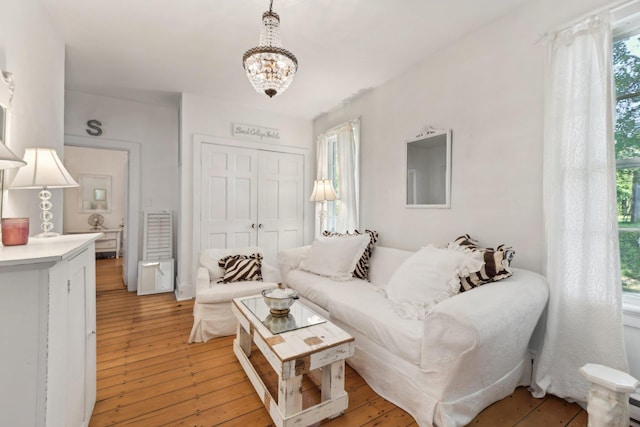 living room featuring a chandelier and light hardwood / wood-style floors