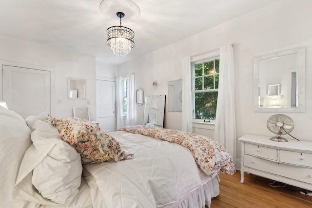 45 Shore Rd, East Setauket, NY 11733 - bedroom with a chandelier and wood finished floors