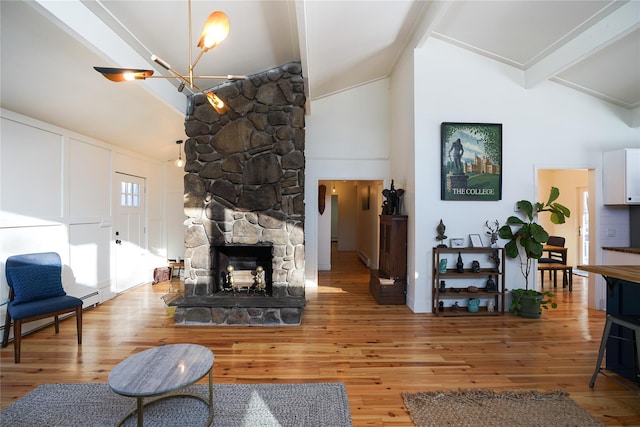 living room with beam ceiling, high vaulted ceiling, a notable chandelier, a fireplace, and hardwood / wood-style floors