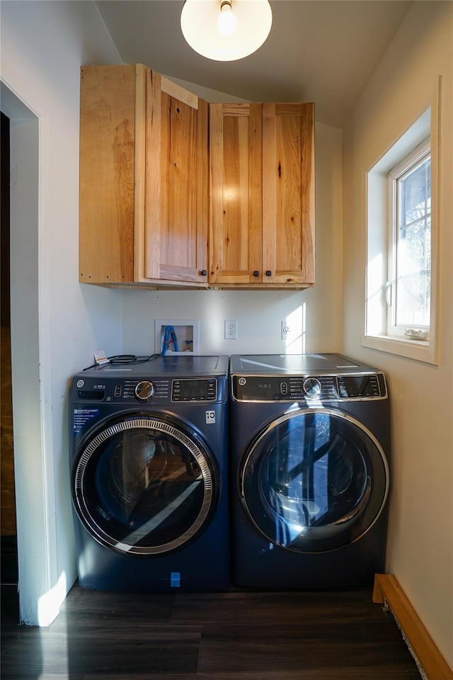 clothes washing area with cabinets and washing machine and dryer