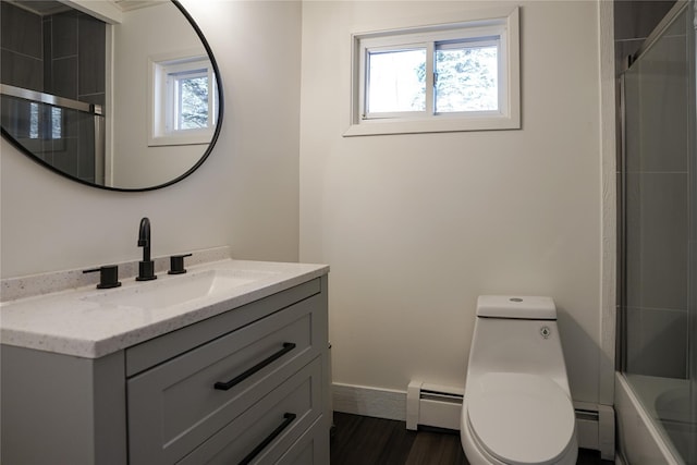 full bathroom with hardwood / wood-style floors, vanity, toilet, and a baseboard radiator