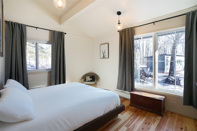 bedroom with lofted ceiling with beams, light hardwood / wood-style flooring, multiple windows, and a baseboard heating unit