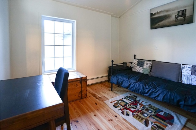 bedroom featuring hardwood / wood-style flooring, vaulted ceiling, baseboard heating, and multiple windows