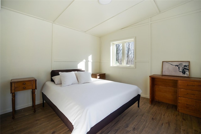 bedroom featuring dark hardwood / wood-style floors and vaulted ceiling