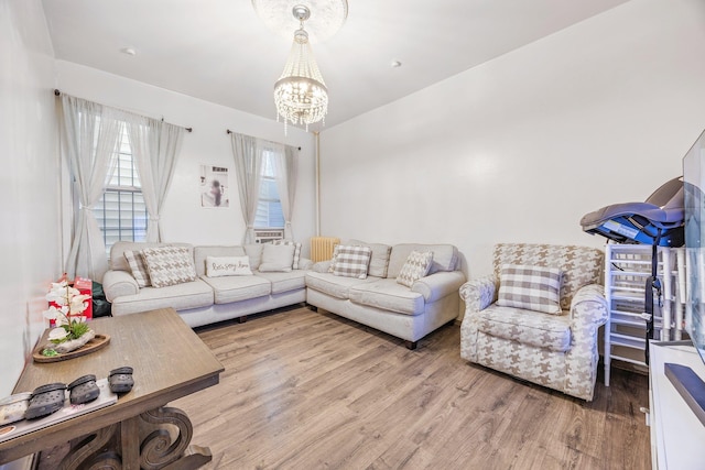 living room with light hardwood / wood-style flooring and a chandelier