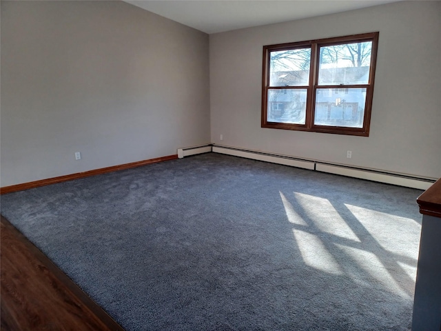 empty room featuring carpet and baseboard heating