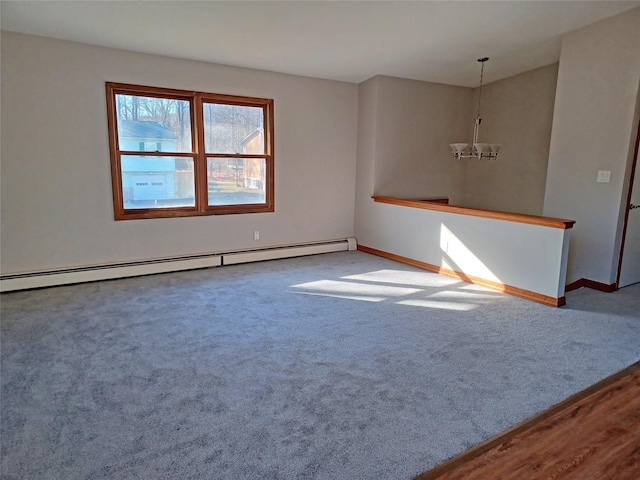 carpeted empty room featuring a baseboard heating unit