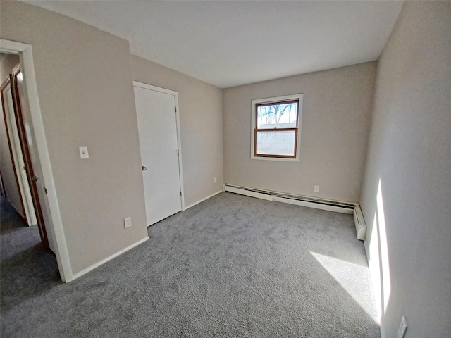 spare room featuring carpet floors and a baseboard radiator