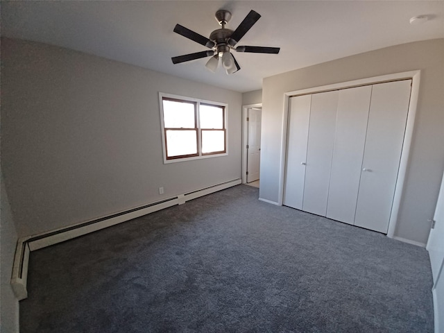 unfurnished bedroom with carpet, ceiling fan, a closet, and a baseboard heating unit