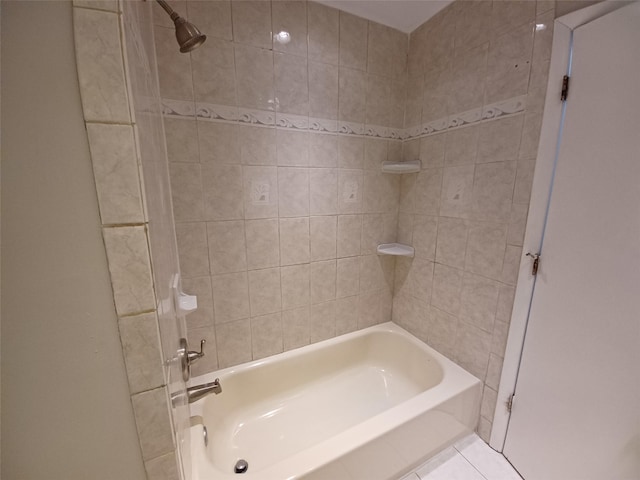 bathroom featuring tile patterned floors and tiled shower / bath combo