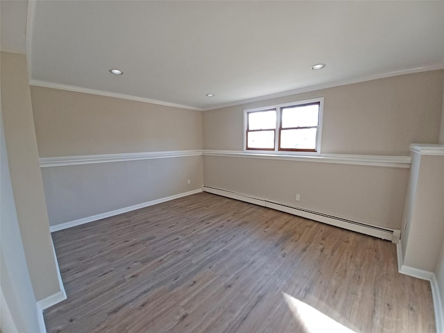 empty room featuring light hardwood / wood-style floors, ornamental molding, and a baseboard radiator