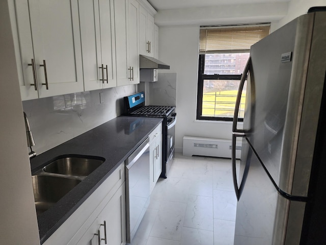 kitchen with white cabinetry, sink, stainless steel appliances, backsplash, and dark stone counters