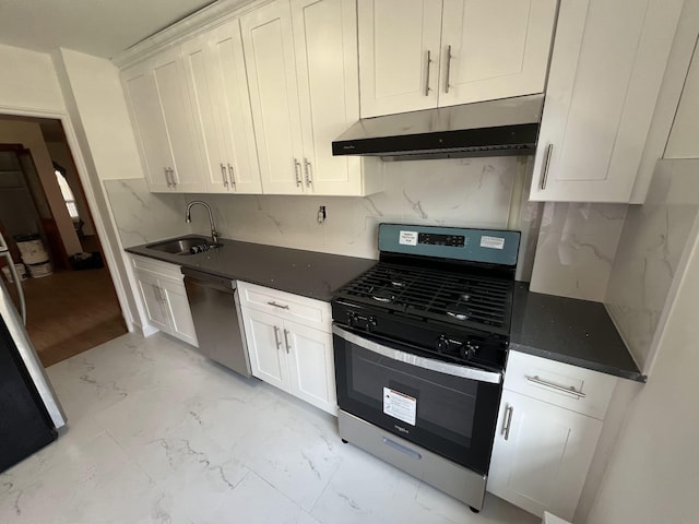 kitchen featuring backsplash, sink, white cabinets, and stainless steel appliances