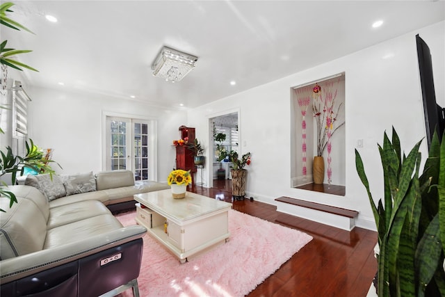 living room with wood-type flooring, an inviting chandelier, and french doors