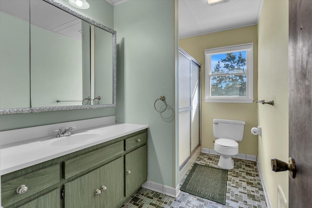 full bath featuring vanity, toilet, a stall shower, baseboards, and ornamental molding