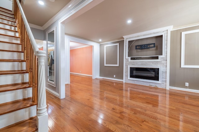 staircase featuring hardwood / wood-style floors and crown molding