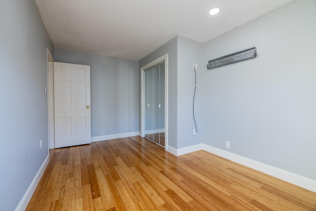 empty room with hardwood / wood-style flooring