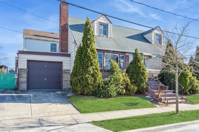 view of front of home featuring a garage and a front lawn