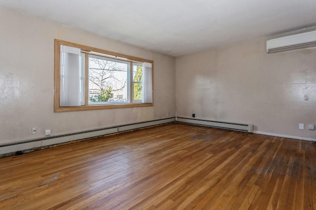 empty room featuring a wall mounted air conditioner and hardwood / wood-style flooring