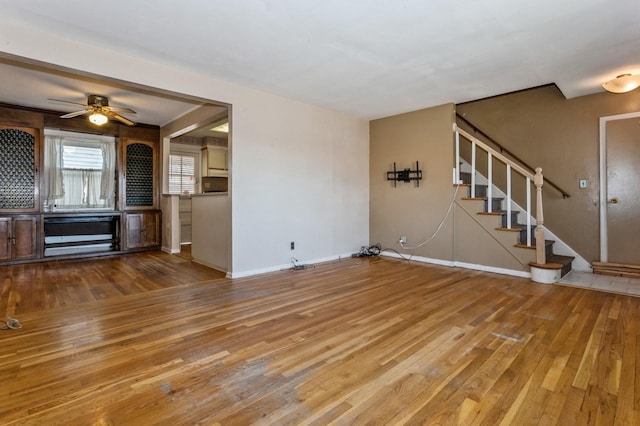 unfurnished living room with ceiling fan and hardwood / wood-style flooring