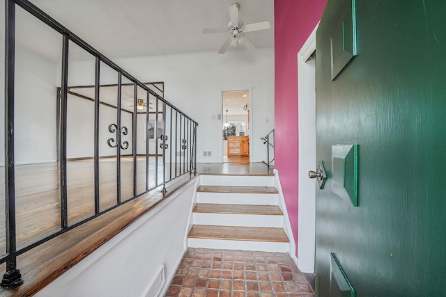 staircase with tile patterned floors and ceiling fan