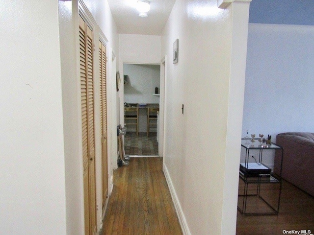 corridor featuring dark hardwood / wood-style floors