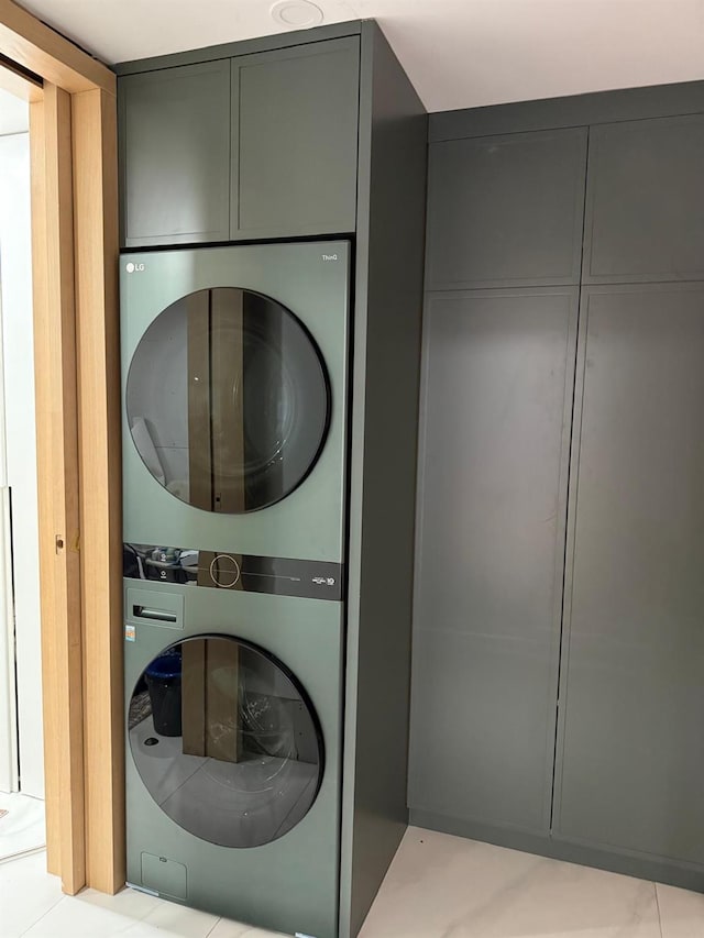 clothes washing area with stacked washer and dryer and laundry area