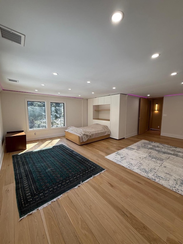 unfurnished bedroom with light wood-style floors, visible vents, and recessed lighting