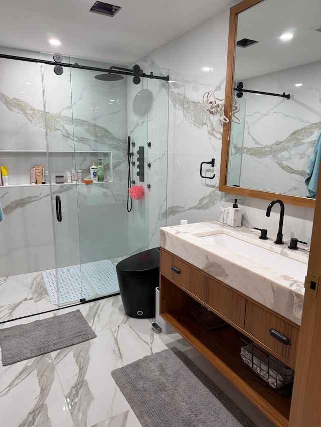 bathroom featuring a marble finish shower, visible vents, toilet, marble finish floor, and vanity