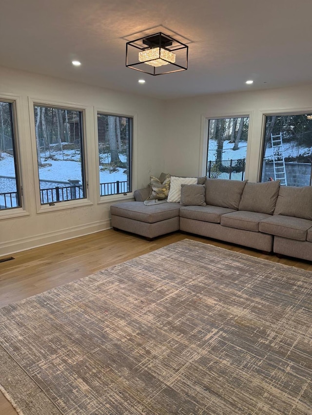 unfurnished living room featuring baseboards, wood finished floors, visible vents, and recessed lighting