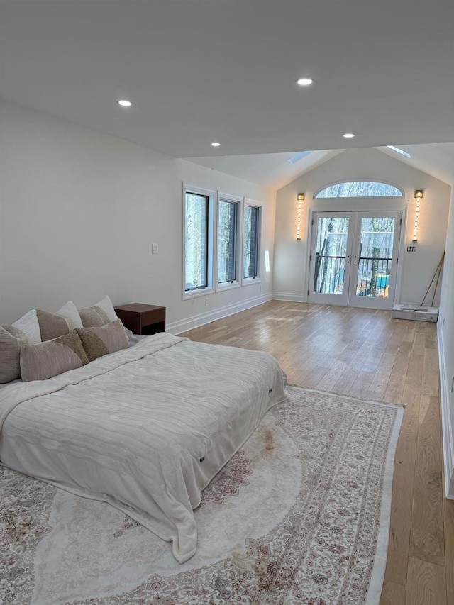 unfurnished bedroom with recessed lighting, access to exterior, vaulted ceiling, french doors, and light wood finished floors