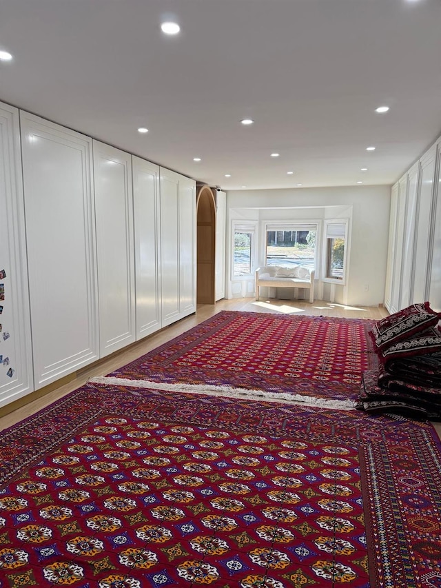 interior space with recessed lighting and arched walkways