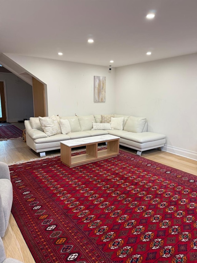 living area with recessed lighting and wood finished floors