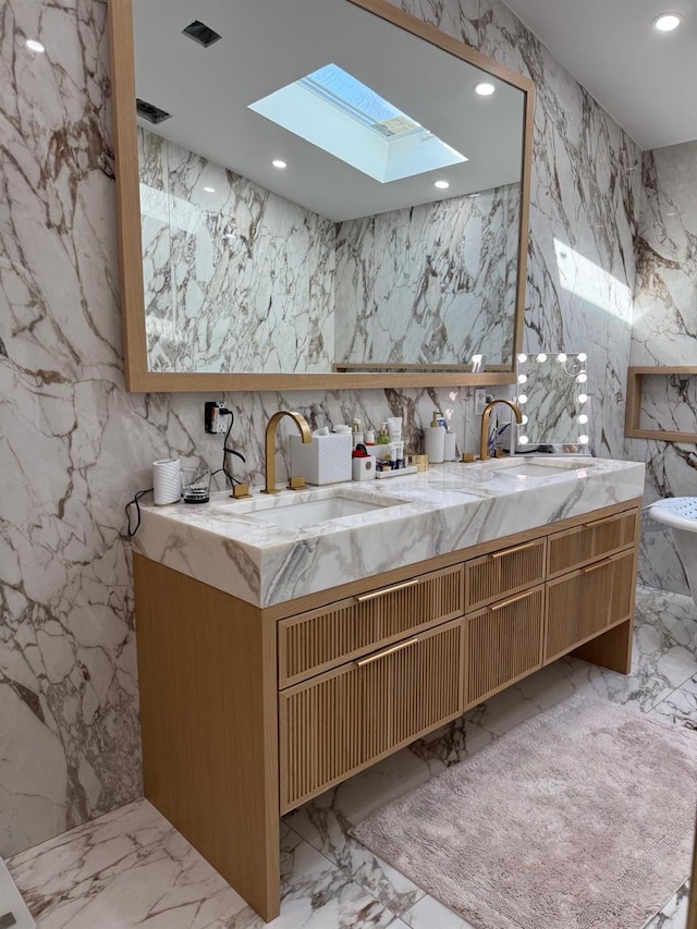 full bathroom featuring recessed lighting, a sink, and stone wall