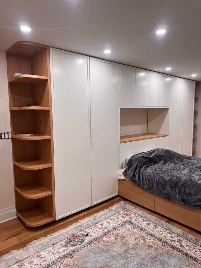 bedroom featuring wood finished floors and recessed lighting