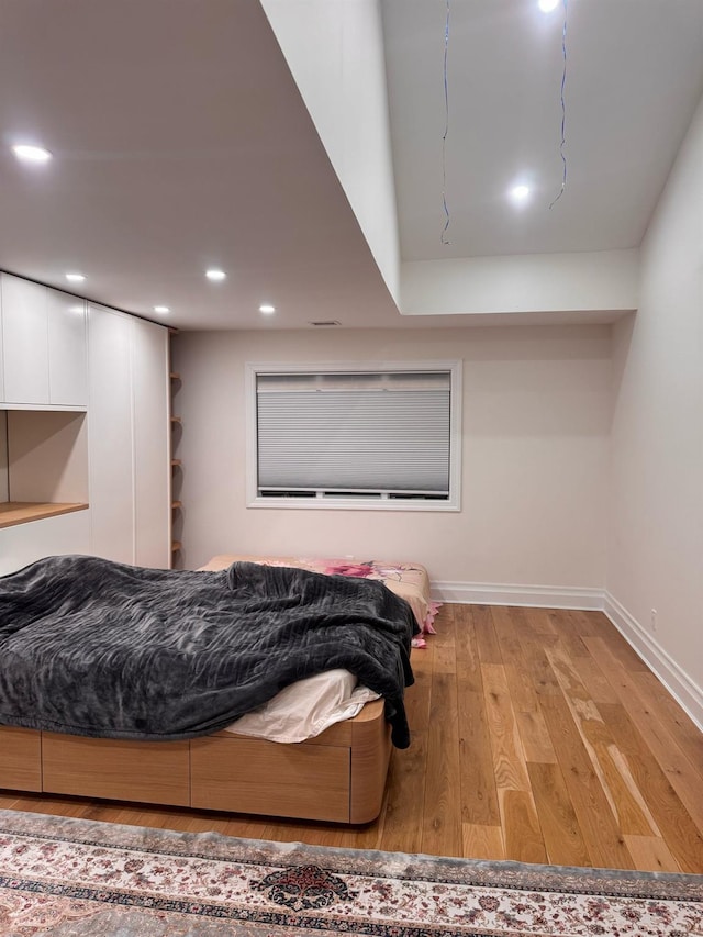 bedroom featuring recessed lighting, light wood-style flooring, and baseboards