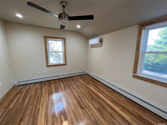 spare room with plenty of natural light, a baseboard radiator, and a wall mounted air conditioner