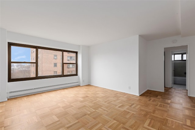 unfurnished room featuring light parquet flooring and baseboard heating