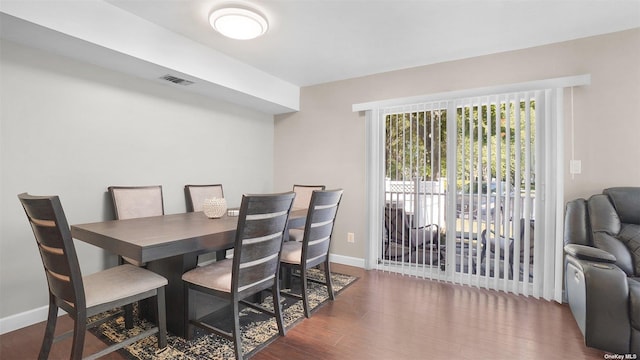 dining space featuring dark wood-type flooring