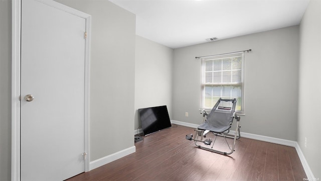 workout area with dark wood-type flooring