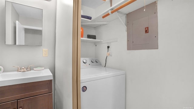 laundry room with electric panel, sink, and washer / dryer